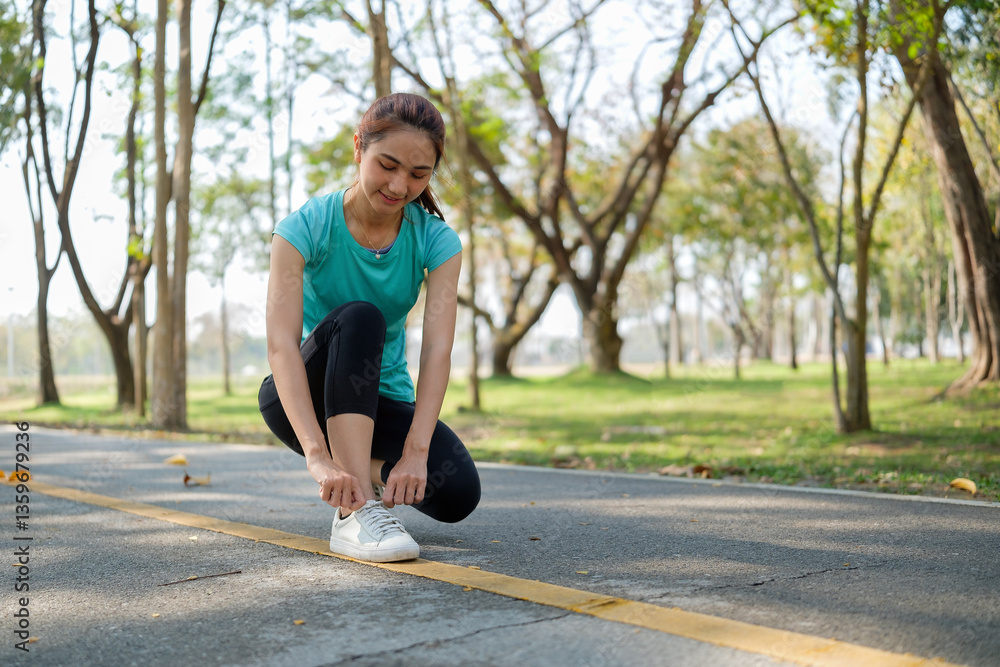 Young woman tying her sneakers, get ready for an outdoor workout. Fitness and healthy lifestyles concept. Young woman tying her sneakers, get ready for an outdoor workout. Fitness and healthy lifestyles concept.