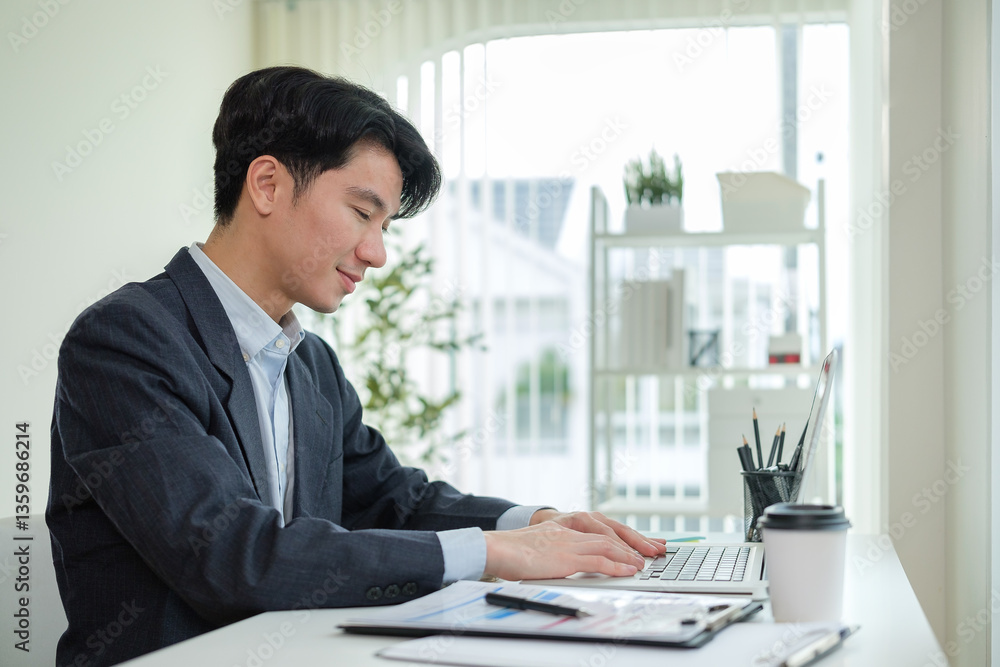 Young entrepreneur analyzing financial data on laptop and planning strategy at modern office. Young entrepreneur analyzing financial data on laptop and planning strategy at modern office.