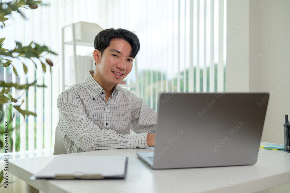Confident businessman working on his laptop in a bright and contemporary office. Confident businessman working on his laptop in a bright and contemporary office.