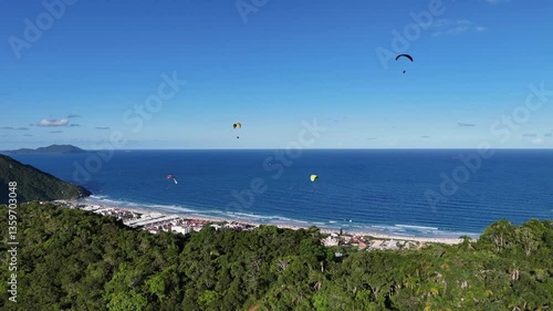 Kite surfing adventure over beautiful coastal waves and lush landscape