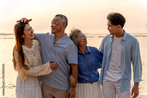Happy family beach vacations.Group of multi generation family little girl with parents and grandparents relax and enjoy together on the beach.
