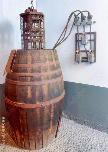 Vintage winery barrel, wooden cask with metal hoops, rustic cage mechanism, old electrical panel, industrial heritage glows, historical setting unfolds. Winery decor, vintage backgrounds.