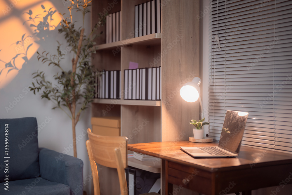 Fototapeta premium Asian businesswoman taking notes on a sticky note while reviewing a summary report on her computer in the office, focused on improving efficiency and productivity