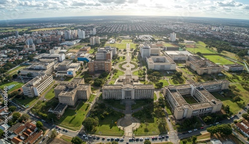 Aerial view of a university campus and cityscape on a bright, sunny day.