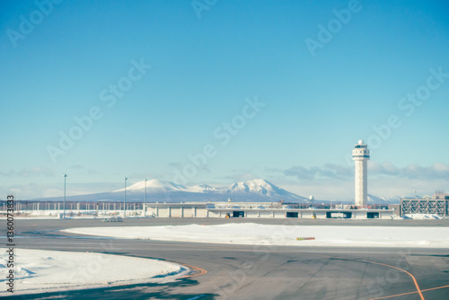 A view of the runway and control tower of New Chitose Airport