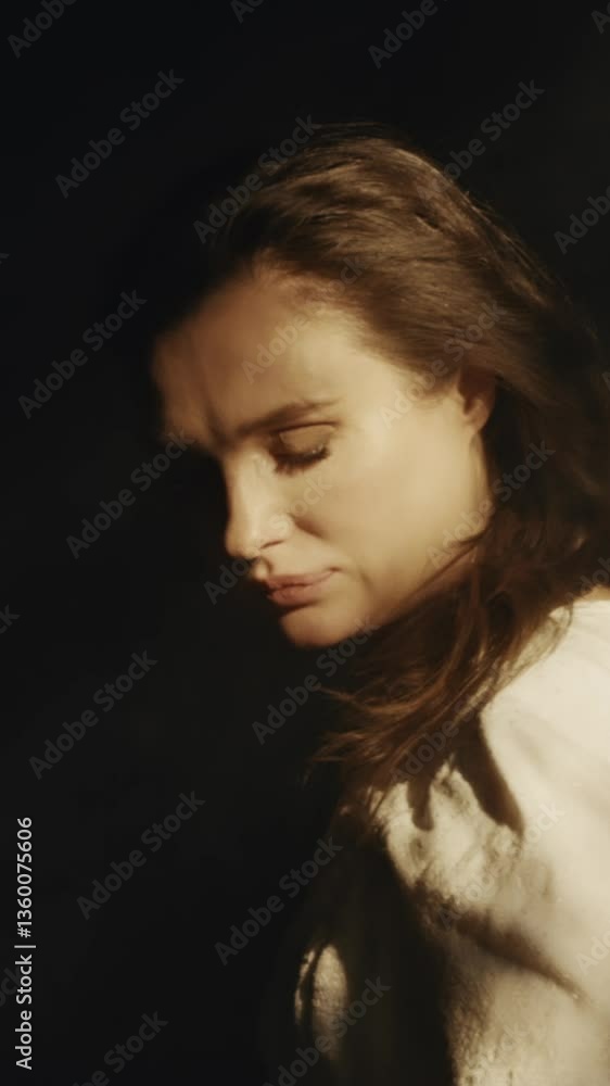 A young woman in a white long dress approaches a colony in a dark Gothic church. Contrasting shadows. Fashion and Cinematic concept A young woman in a white long dress approaches a colony in a dark Gothic church. Contrasting shadows. Fashion and Cinematic concept