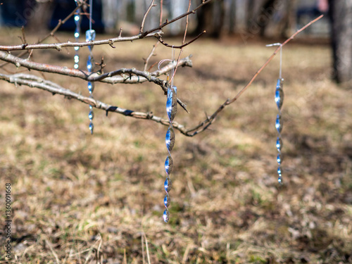 Bird and animal deterrent rods. Protecting fruit trees from deer and rabbits. Shiny reflective spiral plastic rods that spin in the wind