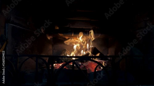 Home fireplace with red flame and firewood. 4K video relaxing endless footage