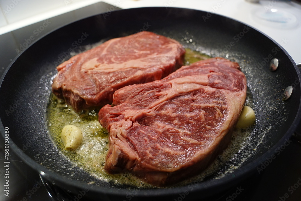 Close up of a juice beef steak being cooked Close up of a juice beef steak being cooked