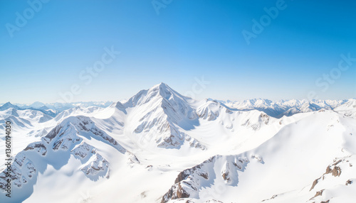 Majestic snow-covered mountain peaks under clear blue sky, winter beauty