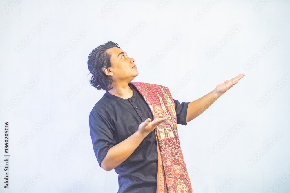 Asian Muslim men pointing to the copy space beside her, isolated by white background. Ramadan and Eid Mubarak concept.
