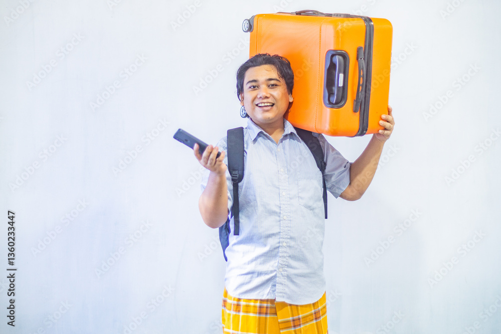 Portrait Asian muslim man carrying suitcase while holding mobile phone with copy space inside. Concept Going home for Eid Mubarak. Isolated image on white background