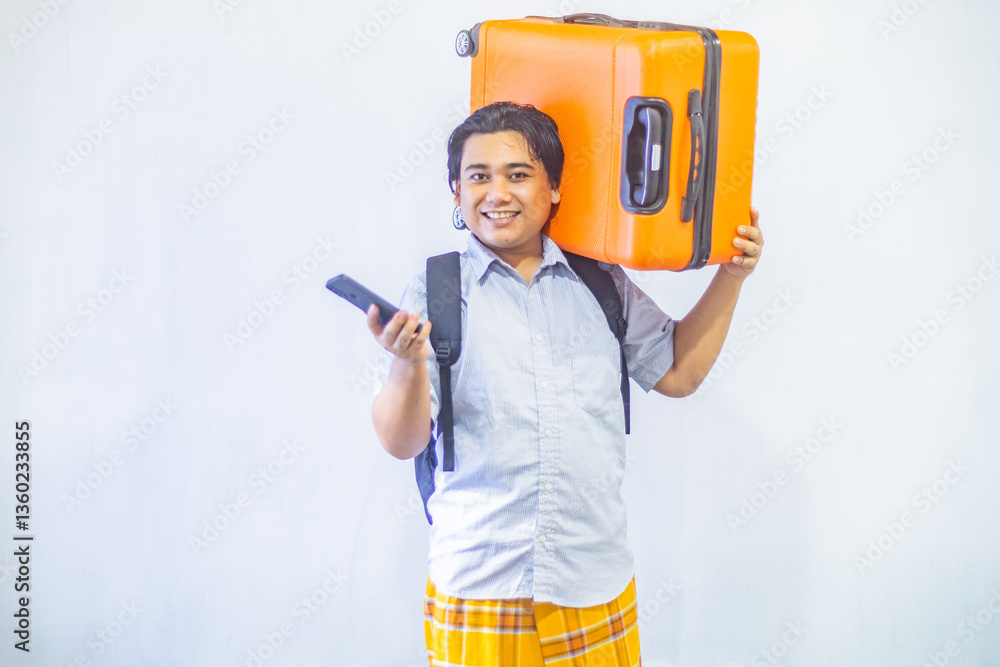 Portrait Asian muslim man carrying suitcase while holding mobile phone with copy space inside. Concept Going home for Eid Mubarak. Isolated image on white background