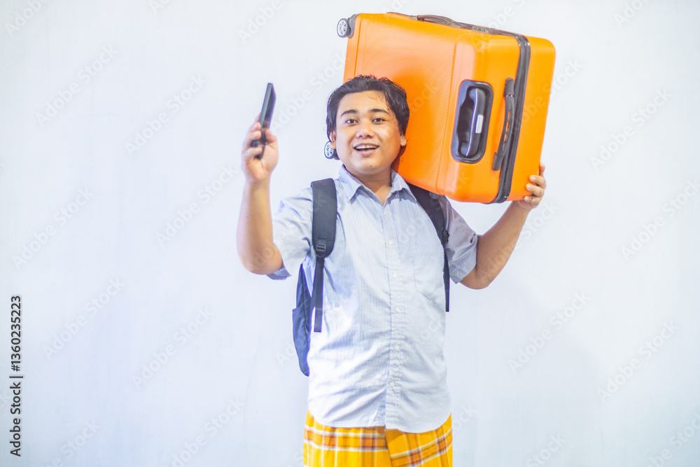 Portrait Asian muslim man carrying suitcase while holding mobile phone with copy space inside. Concept Going home for Eid Mubarak. Isolated image on white background