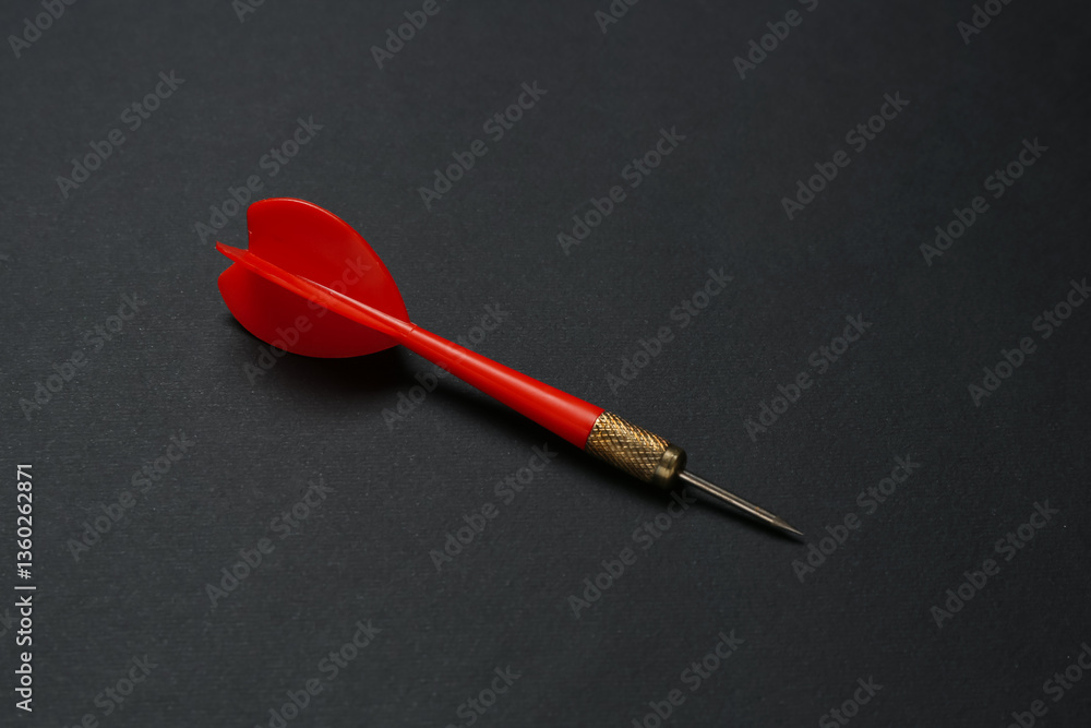 One red dart arrow on black background One red dart arrow on black background