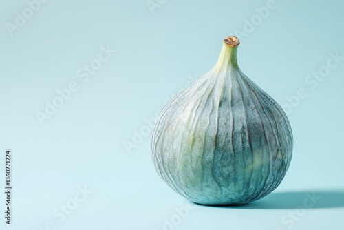 Wallpaper Mural A single ripe fig is displayed against a simple light background Torontodigital.ca