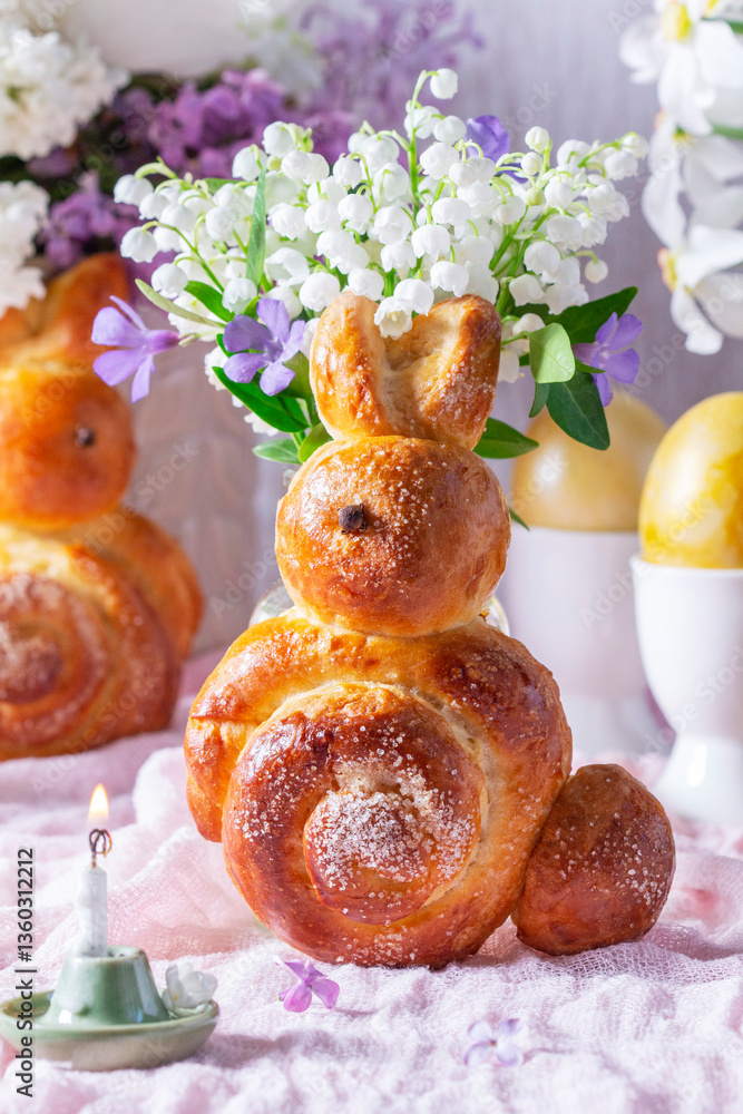 Easter composition made of rabbits, painted eggs and spring bouquets.
