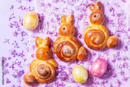 Obraz na płótnie Easter composition made of sweet buns in the shape of a rabbit, eggs and lilacs. w salonie