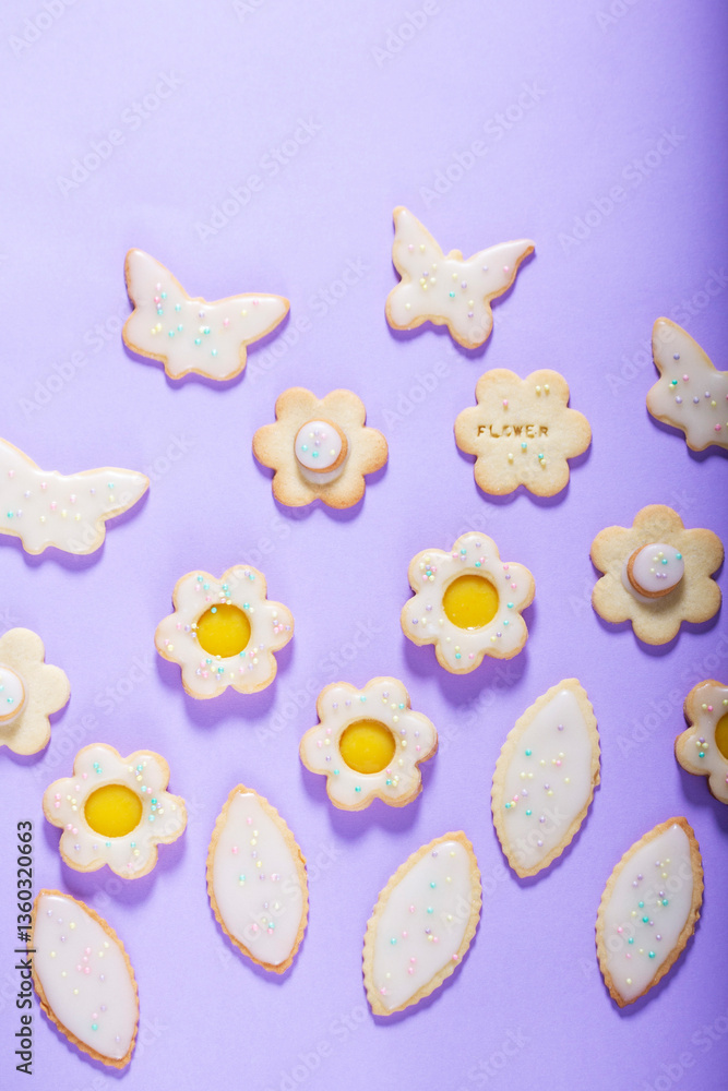 Shortbread cookies with lemon filling in the shape of butterflies, flowers and leaves.