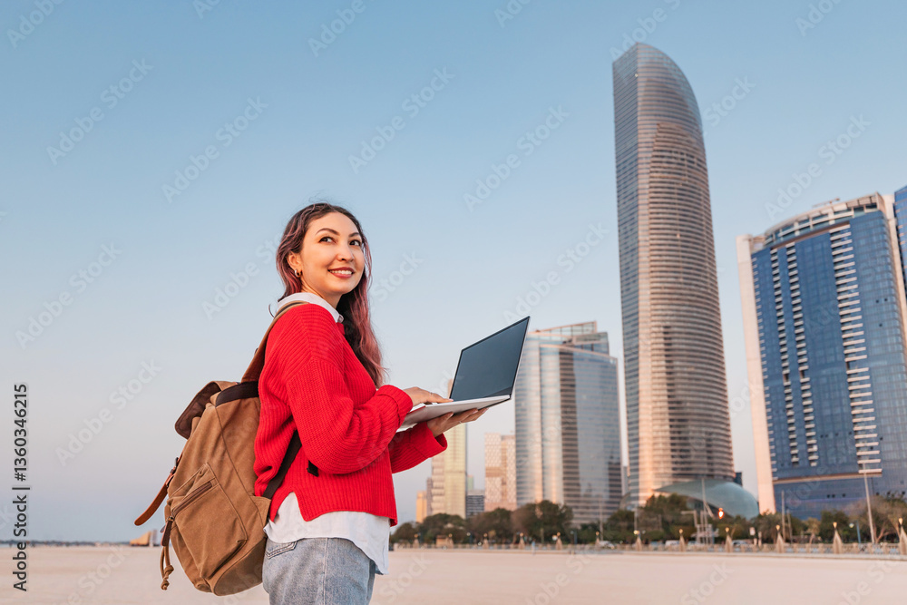 Young female student working on laptop in Abu Dhabi, United Arab Emirates