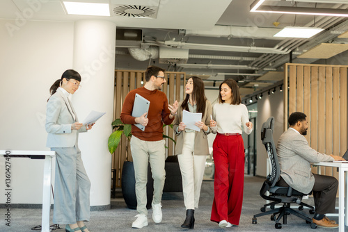 Fotografija Collaborating in a modern office environment during a busy workday with creative