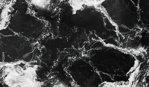 Black and white rough sea surface top shot. Water gently flowing over the rocks. Waves in ocean Splashing Waves