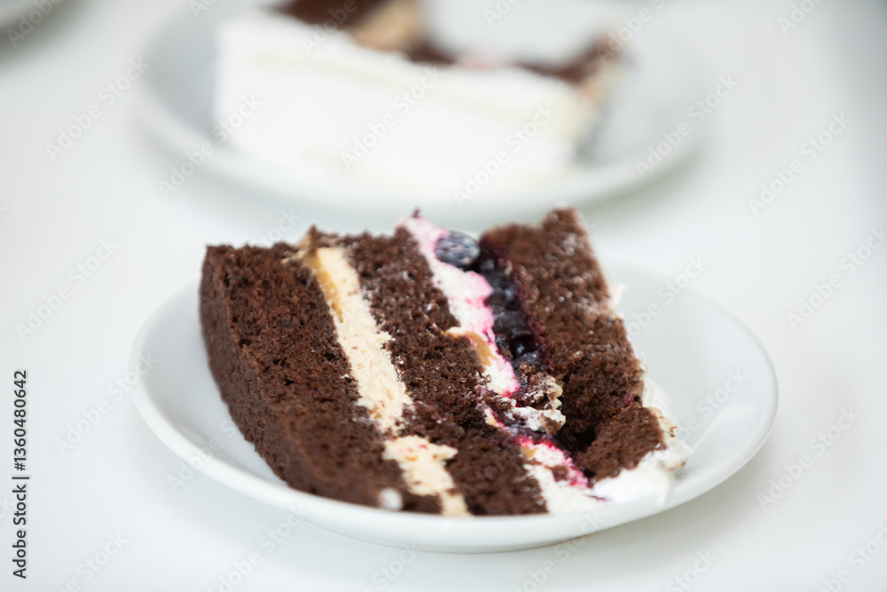 Indulge in a Delicious Slice of Chocolate Cake Crafted with Creamy Filling and Fresh Berries Indulge in a Delicious Slice of Chocolate Cake Crafted with Creamy Filling and Fresh Berries