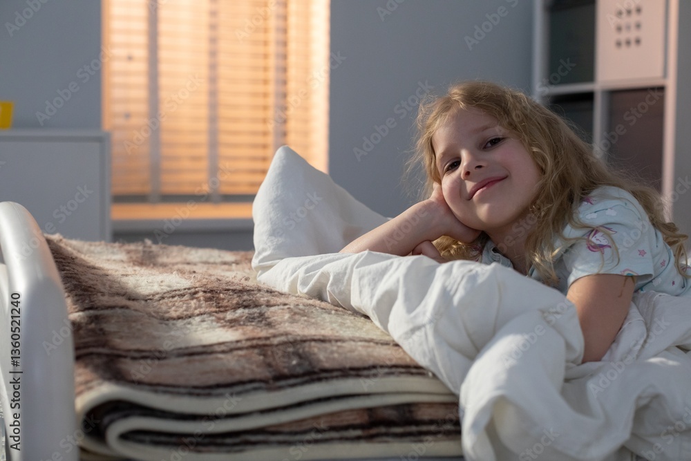 A little child peacefully nestled in bed with cozy blankets and soothing soft lighting A little child peacefully nestled in bed with cozy blankets and soothing soft lighting