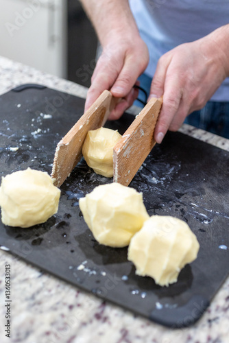 Homemade butter being shaped with wooden paddles.