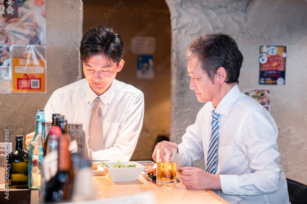 上司と二人で飲んで話すビジネスマン 上司と二人で飲んで話すビジネスマン
