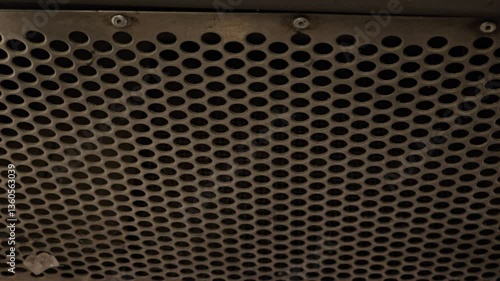 Metal grille with large holes. The grille looks dirty. Camera movement