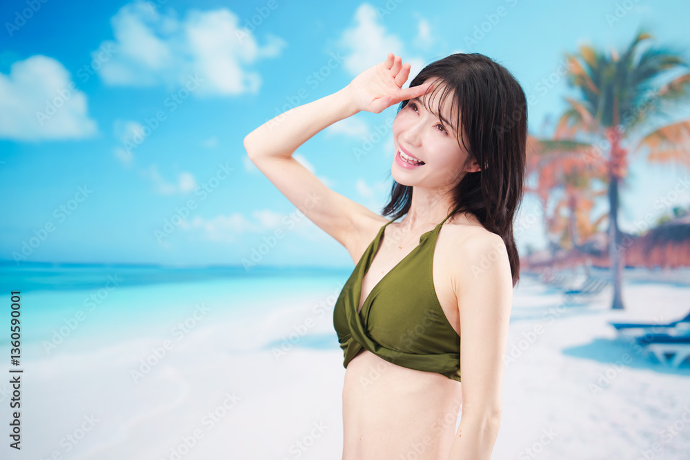 Naklejka premium 青空のビーチで水着を着た若い女性