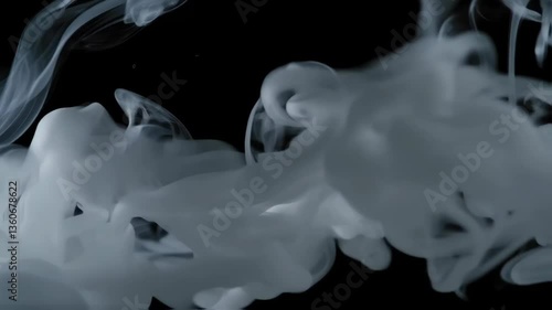 White smoke swirls against a dark backdrop, creating an engaging abstract background. The mesmerizing patterns shift and change, drawing attention effortlessly.