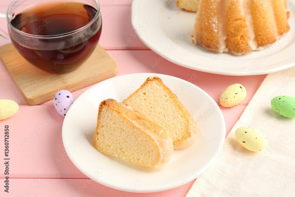 Pieces of delicious bundt cake, Easter eggs and tea on pink wooden table, closeup Pieces of delicious bundt cake, Easter eggs and tea on pink wooden table, closeup