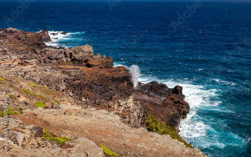 Photography Explore the rugged coastline of northern Maui with Nakalele Blowhole, a natural water blowhole spouting into the ocean under a clear blue sky