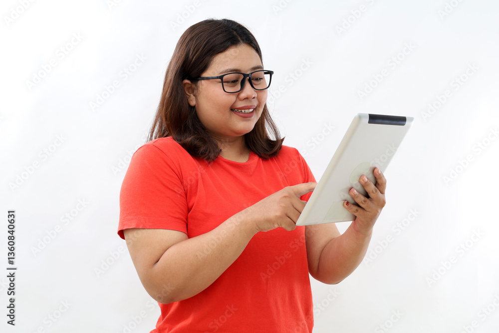 Smiling busy young asian business woman manager using tablet computer, happy business woman executive looking at tab device analyzing finance trading market data working standing over white background Smiling busy young asian business woman manager using tablet computer, happy business woman executive looking at tab device analyzing finance trading market data working standing over white background