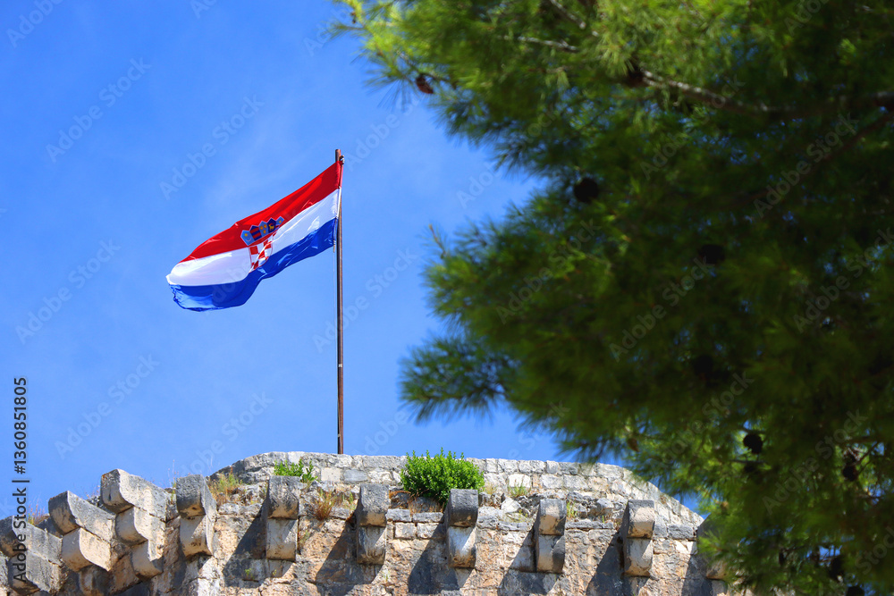 Historical Kamerlengo Fortress in Trogir, Croatia and Croatian flag.