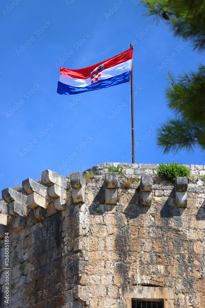 Historical Kamerlengo Fortress in Trogir, Croatia and Croatian flag.
