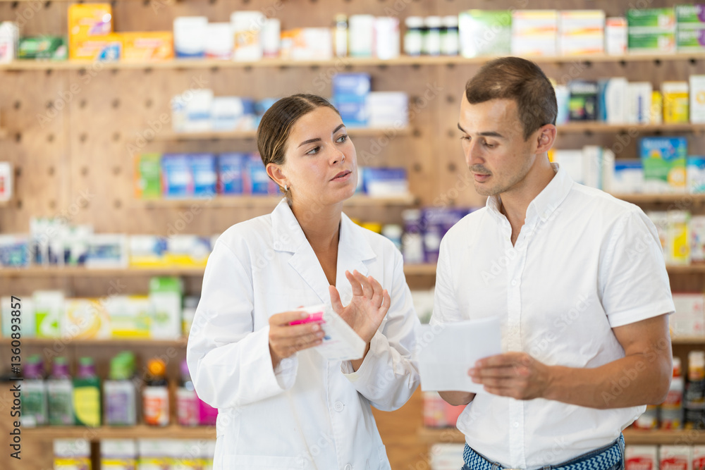 Client submits give medical statement to girl pharmacist and receives box with medicinal product from specialist. Interactions between pharmacy employee and visitors, prescription drugs Client submits give medical statement to girl pharmacist and receives box with medicinal product from specialist. Interactions between pharmacy employee and visitors, prescription drugs