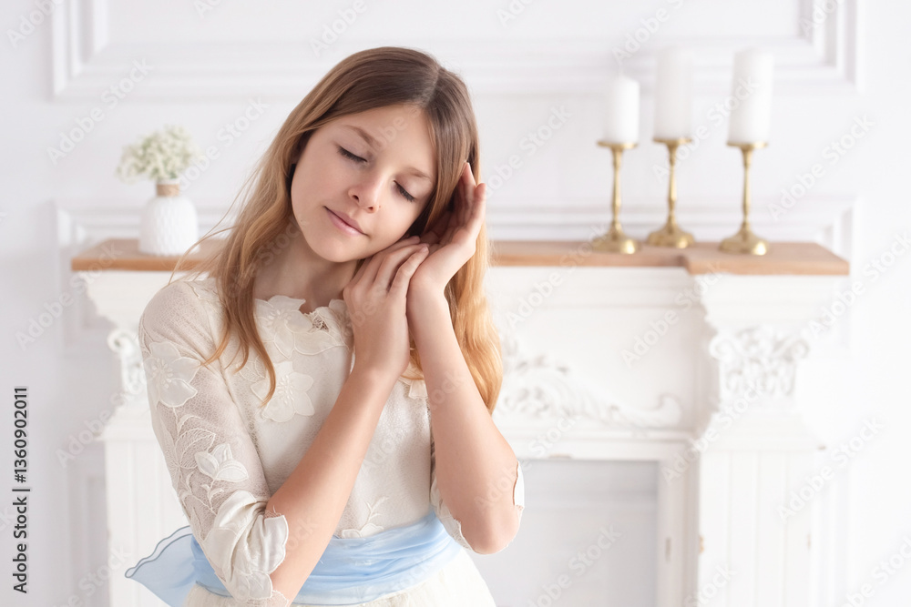 Portrait of a girl in a smart white dress on the day of her first communion Portrait of a girl in a smart white dress on the day of her first communion