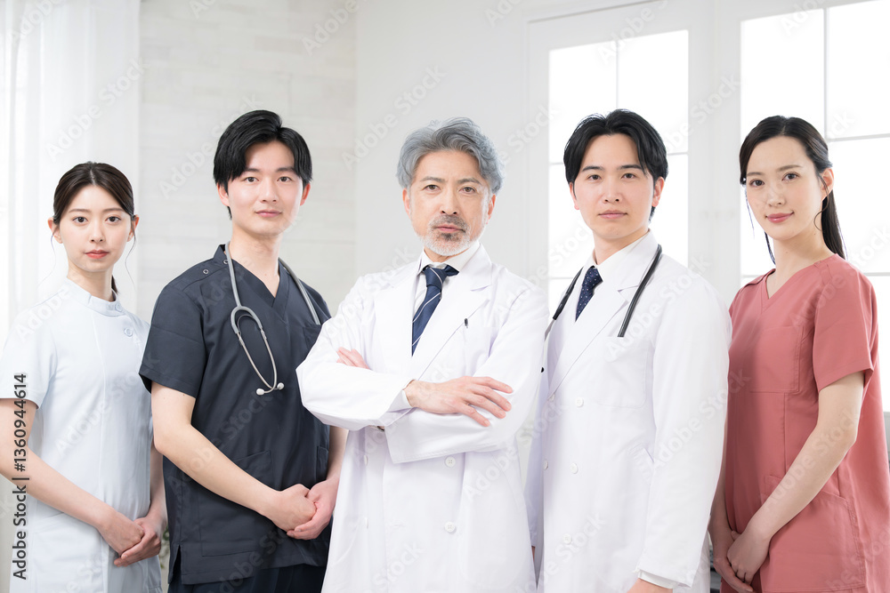 Image of a doctor with cool gray hair and multiple doctors looking at the camera with serious, serious arms folded. Image of a doctor with cool gray hair and multiple doctors looking at the camera with serious, serious arms folded.