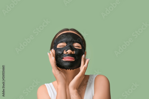 Young woman with black clay...
