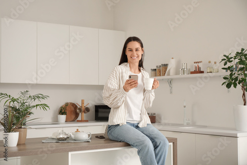 Young pretty woman with cup...