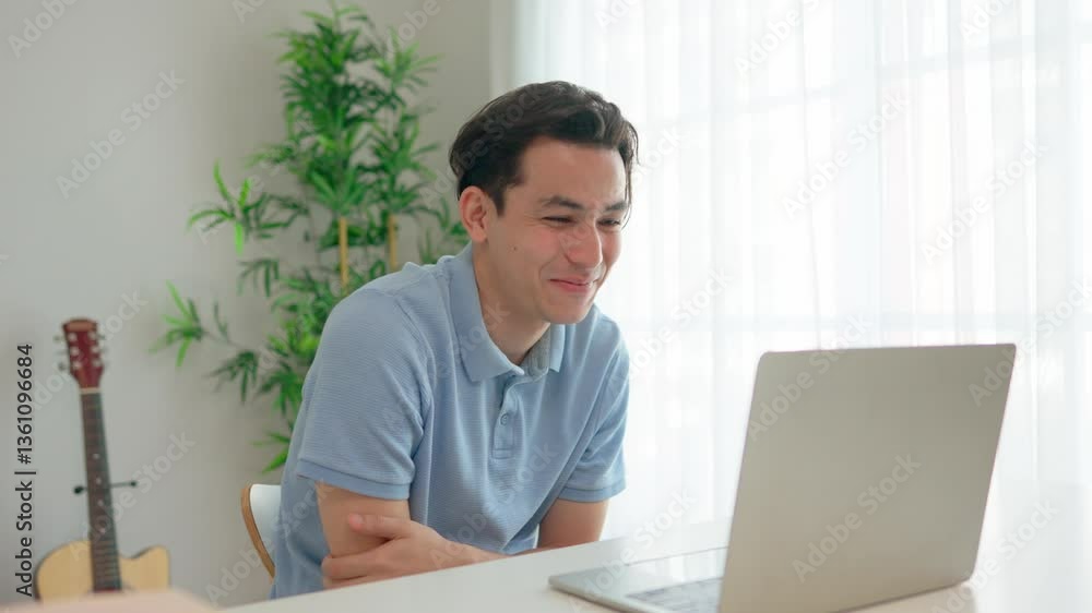 Asian young handsome man making a remote virtual video call in house. Asian young handsome man making a remote virtual video call in house.