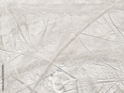 Ice background with marks from skating and hockey. Ice hockey rink scratches surface