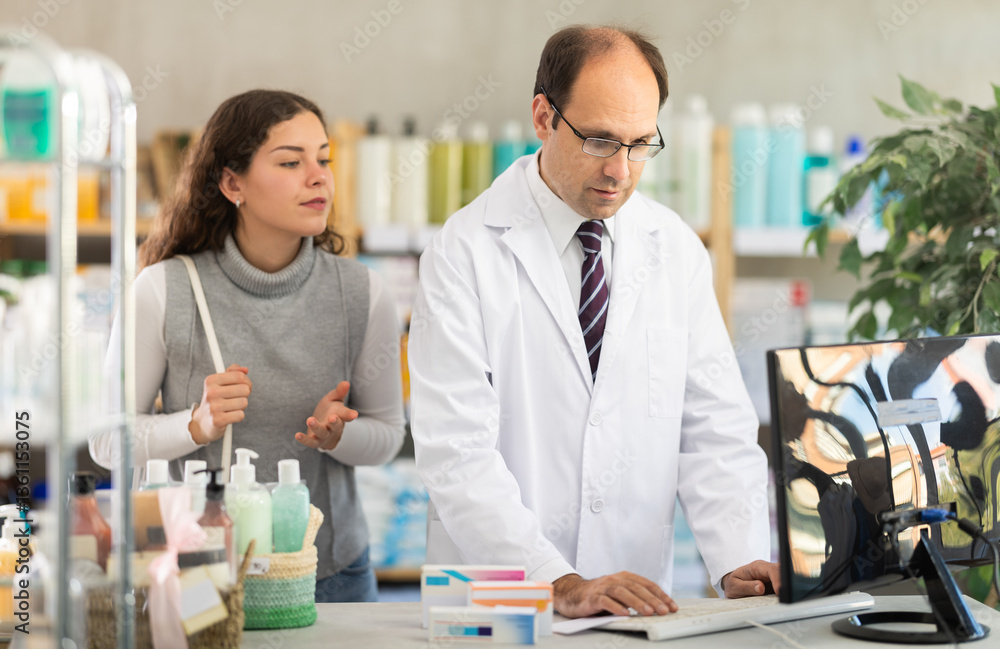 Young woman buyer scanning qr code for box of pills with adult man pharmacist in pharmacy Young woman buyer scanning qr code for box of pills with adult man pharmacist in pharmacy