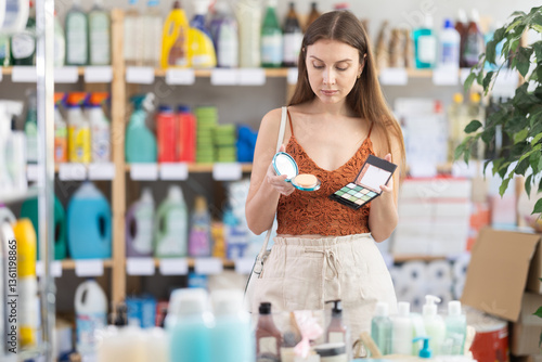 Wallpaper Mural Young woman buyer choosing cosmetics for makeup in household chemicals store Torontodigital.ca