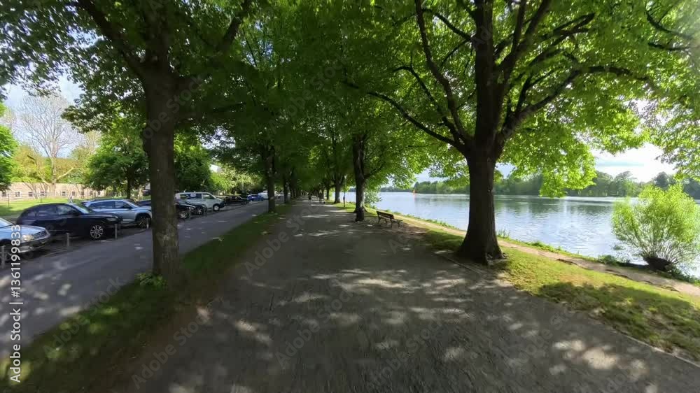 A Scenic Riverside Walkway Surrounded by Lush Green Trees and Beautiful Natural Scenery Maschsee Hannover warp speed A Scenic Riverside Walkway Surrounded by Lush Green Trees and Beautiful Natural Scenery Maschsee Hannover warp speed