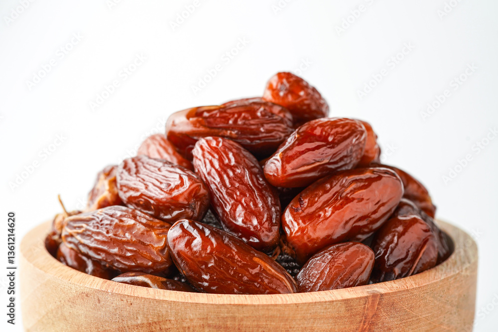 Dates fruit tunisia, Tunisian honey dates, in bowl isolated on white background Dates fruit tunisia, Tunisian honey dates, in bowl isolated on white background