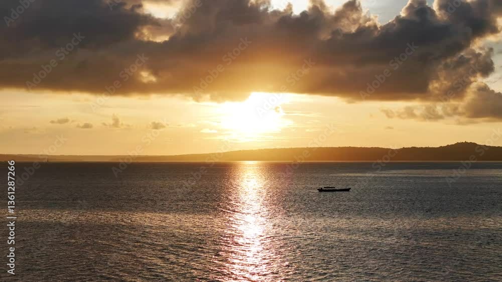 Aerial perspective of a serene sunset over the sea, with scattered clouds glowing in orange light. Aerial perspective of a serene sunset over the sea, with scattered clouds glowing in orange light.